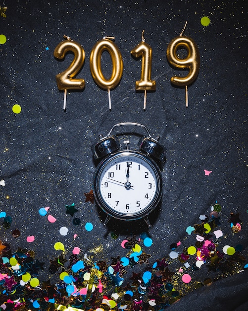 Free Photo 2019 candles and alarm clock with confetti