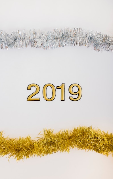 Free photo 2019 inscription with bright tinsel on table