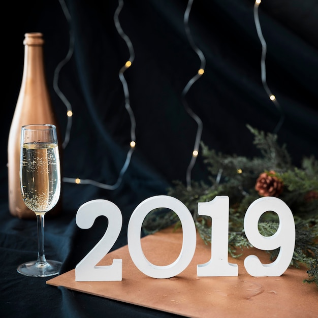 Free Photo 2019 inscription with champagne glass on table 