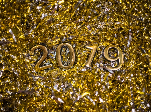 Free Photo 2019 numbers between gold tinsel 