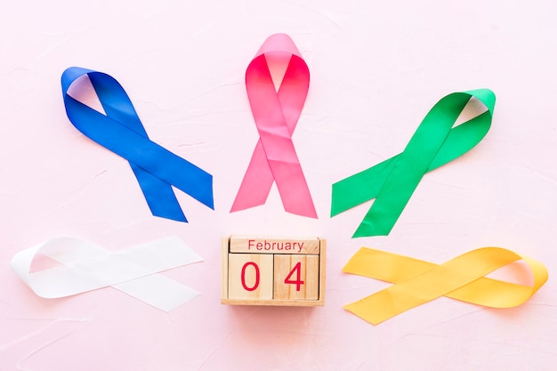 Free Photo 4th february wooden box around the colorful ribbons on pink background