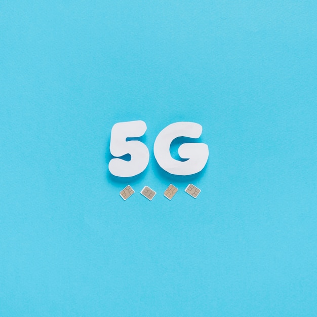 Free photo 5g spelled out on plain background with sim cards