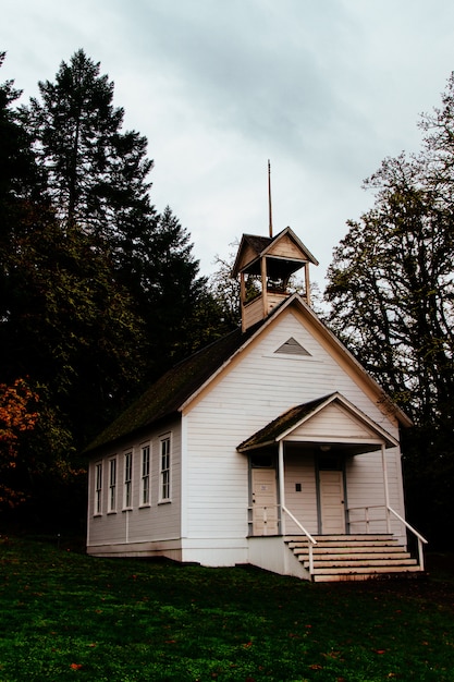 Abandoned closed wooden church in a forest in the countryside