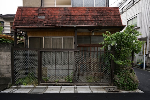 Free photo abandoned house background with rusty fence