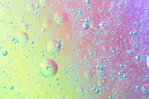 Free photo abstract air bubbles in oil spot on multicolored background