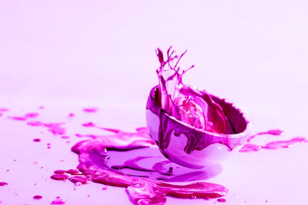 Free photo abstract background with pink paint splash and cup