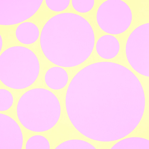 Free photo abstract background with pink paper circle elements on yellow backdrop