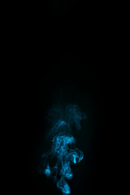 Free photo abstract blue smoke on black background