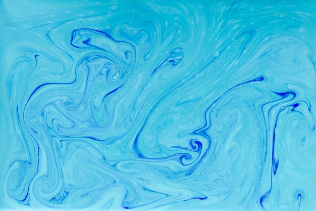 Free photo abstract blue swirls in paint