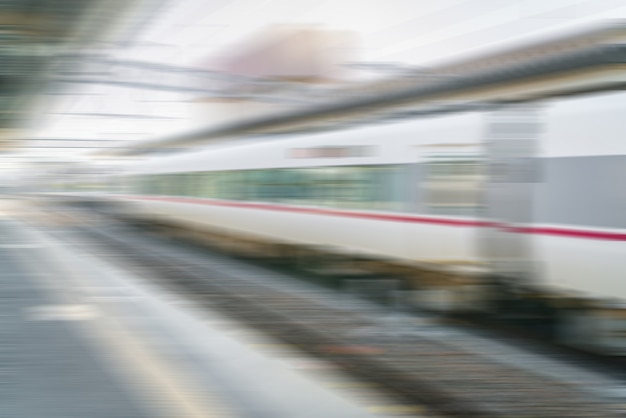 Free photo abstract blur train pulling into the train station .