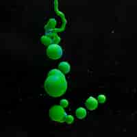 Free photo abstract green acrylic balls on black background