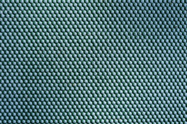 Abstract green metal background. Iron dots texture on outdoor metal wall.