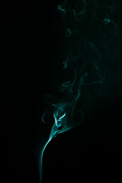 Free Photo abstract green smoke moves upward on black background