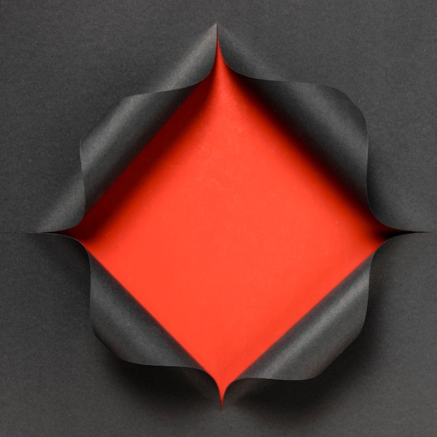 Free Photo abstract red shape on torn black paper