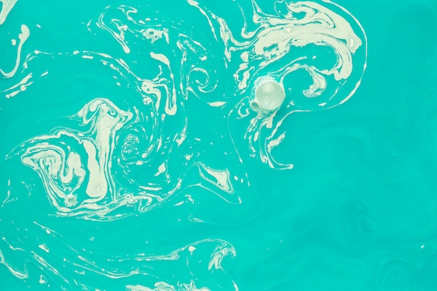 Free photo abstract white liquid mixed with teal flow pattern backdrop