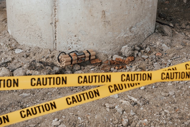 Free photo accident under the bridge. dangerous explosive lying on the ground. yellow caution tape in front