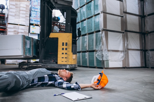 Free Photo an accident at a warehouse, man on floor