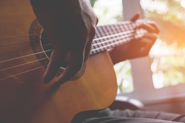 Acoustic guitar guitarist playing. Musical instrument with performer hands.