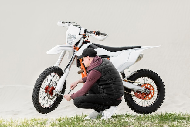 Active man trying to repair motorbike