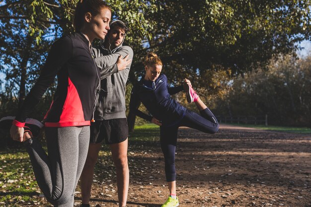 Active people stretching muscles before running