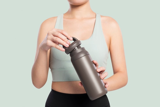 Free Photo active woman holding a stainless steel water bottle