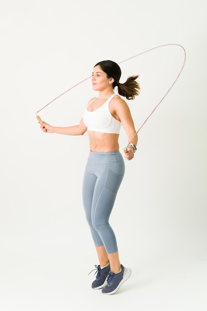 Active woman jumping the rope during a HIIT or cross-training. Young woman with a healthy lifestyle maintaining a slim and toned body with a cardio routine