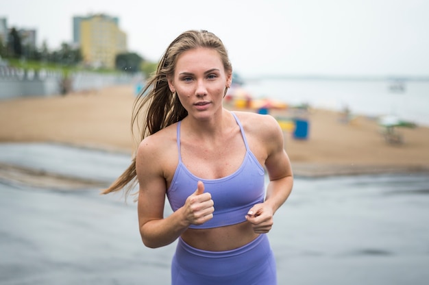 Active woman running outdoor medium shoot