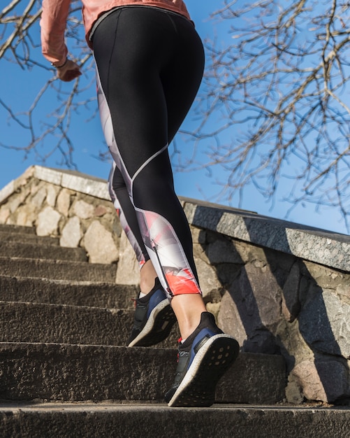 Free photo active woman running on the stairs