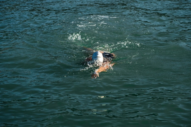 Active young lady enjoying swimming