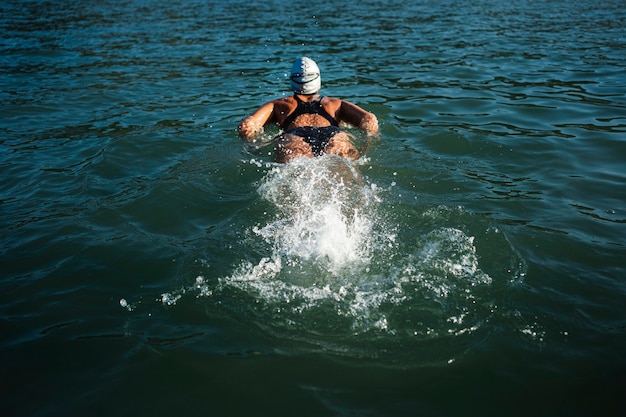 Active young lady enjoying swimming