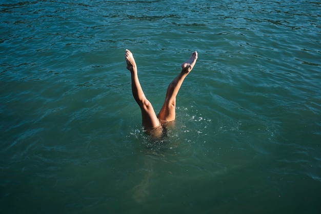 Active young lady enjoying swimming