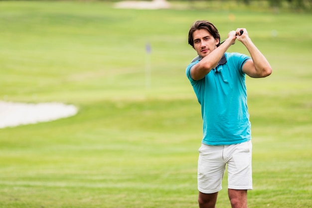 Free photo active young man playing golf