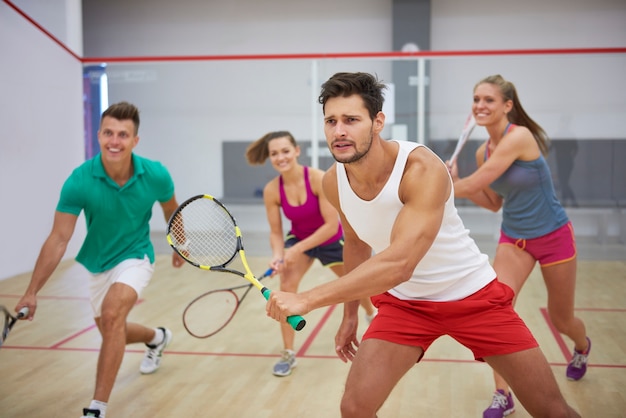 Free photo active young people playing squash