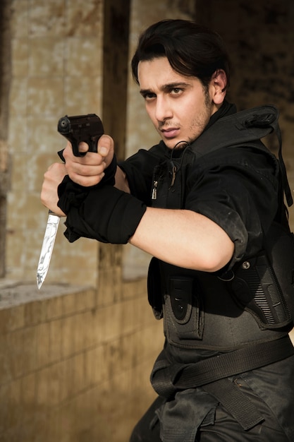 Free Photo an actor performing police scene with a weapon