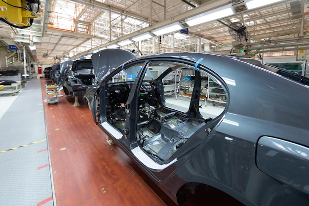 Add details to car body Robotic equipment makes Assembly of car Modern car Assembly at factory