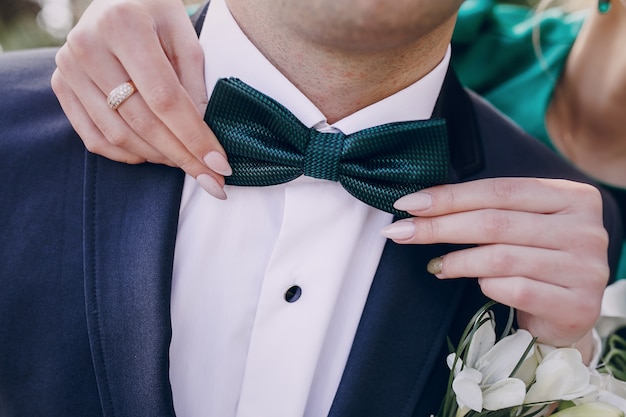 Free Photo adjusting bow tie boyfriend