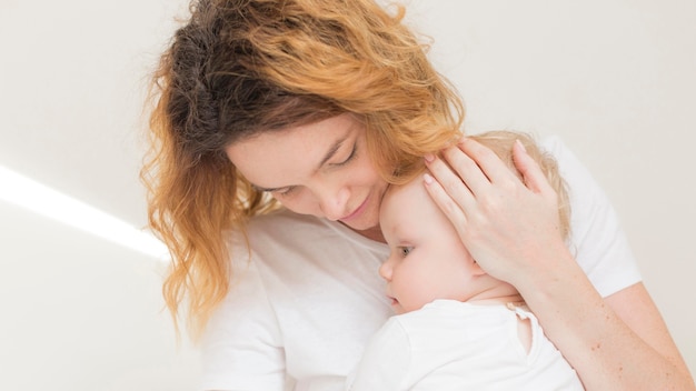 Adorable baby girl together with mother