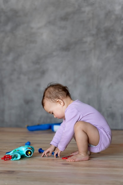 Adorable baby playing on the floor with toy