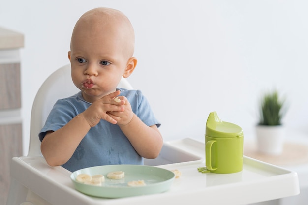 Adorable baby playing with food