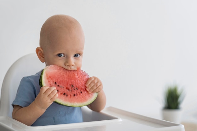 Adorable baby playing with food