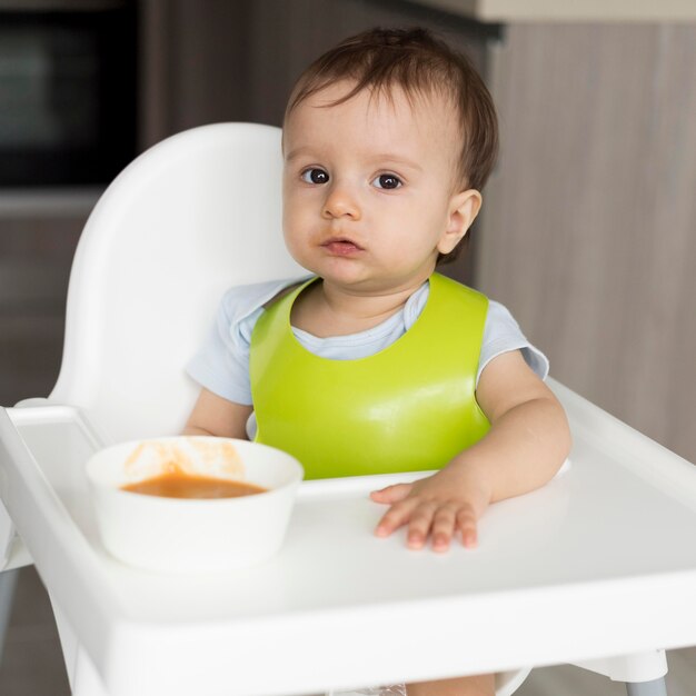 Adorable baby playing with food