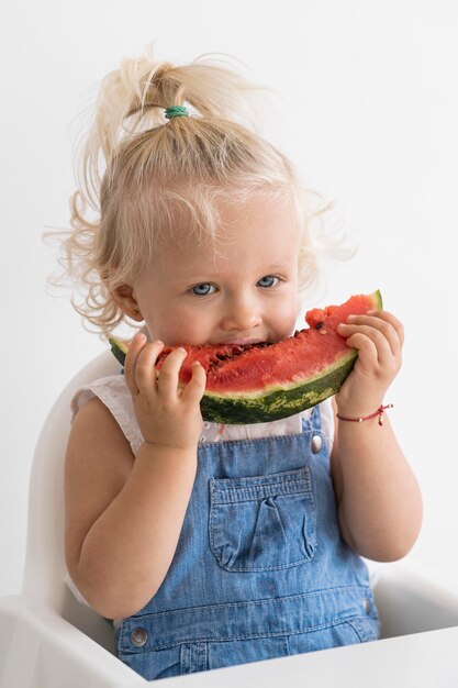 Adorable baby playing with food