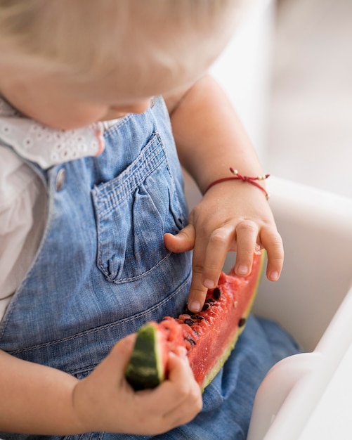 Free photo adorable baby playing with food