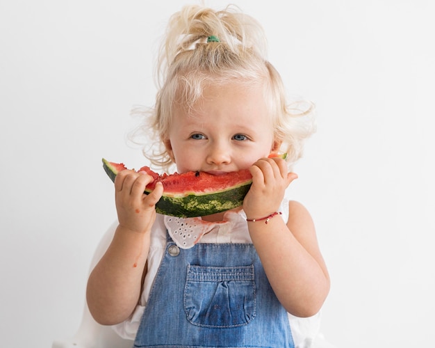 Adorable baby playing with food