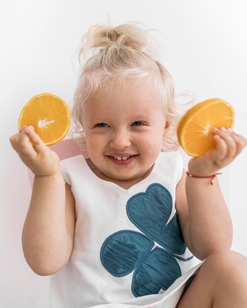 Adorable baby playing with food