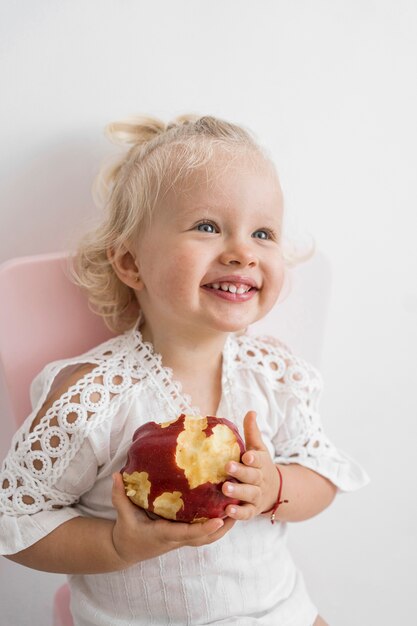 Adorable baby playing with food