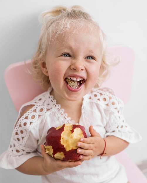 Adorable baby playing with food