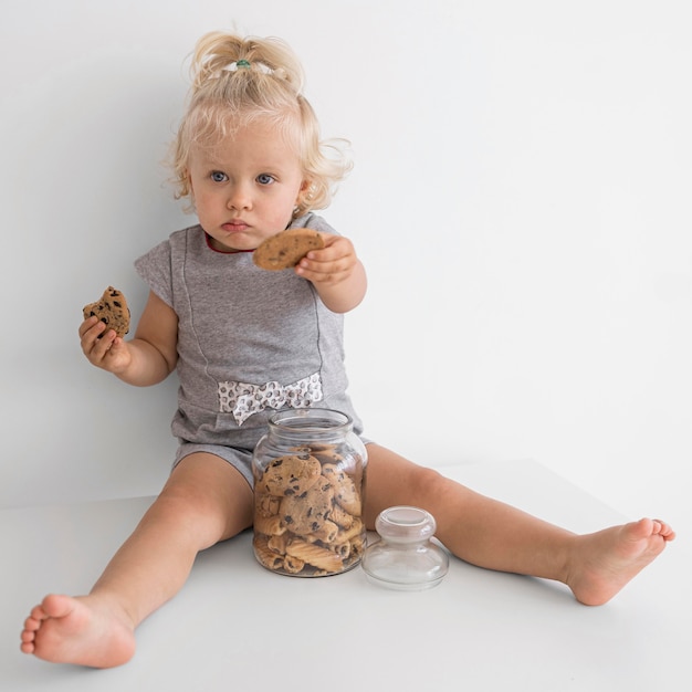 Free Photo adorable baby playing with food