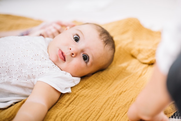 Free photo adorable baby on yellow blanket