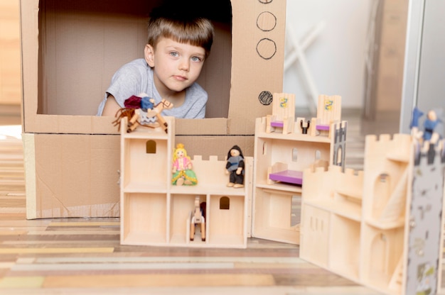 Adorable boy playing with castle